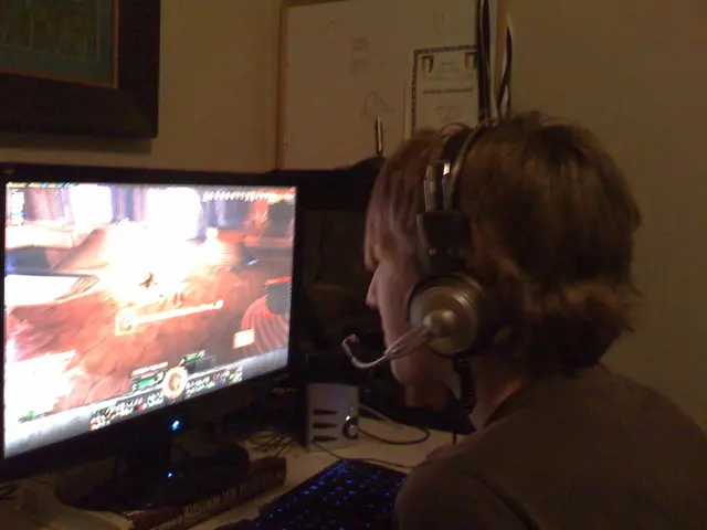 In this picture we observe a guy who is wearing headphones and playing video game in the monitor.