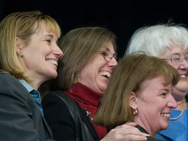 In this picture there some old women standing in the front smiling and looking on the right side....