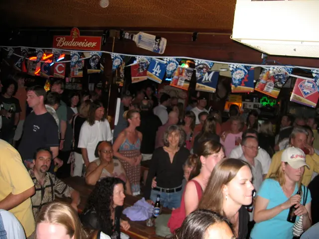 In the right side a woman is standing she wore a blue color t-shirt, beside her there are few other...